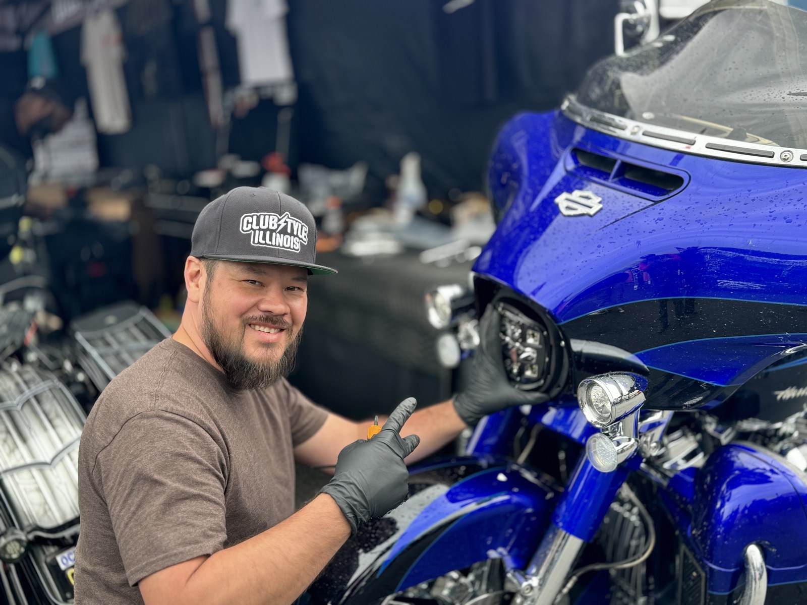 KLEENMOTO rider working beside a blue Harley fairing